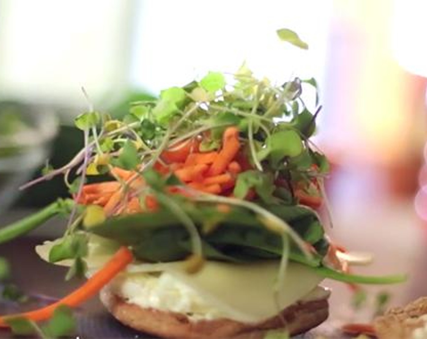 step 3 Spread Mayonnaise (to taste) over both side of the toasted muffin. Run a butter knife around the edge of the egg dish to release. Add it to the muffin. Add the Cheese (1 slice), Fresh Spinach (to taste), Carrots (to taste), and Alfalfa Sprouts (to taste).