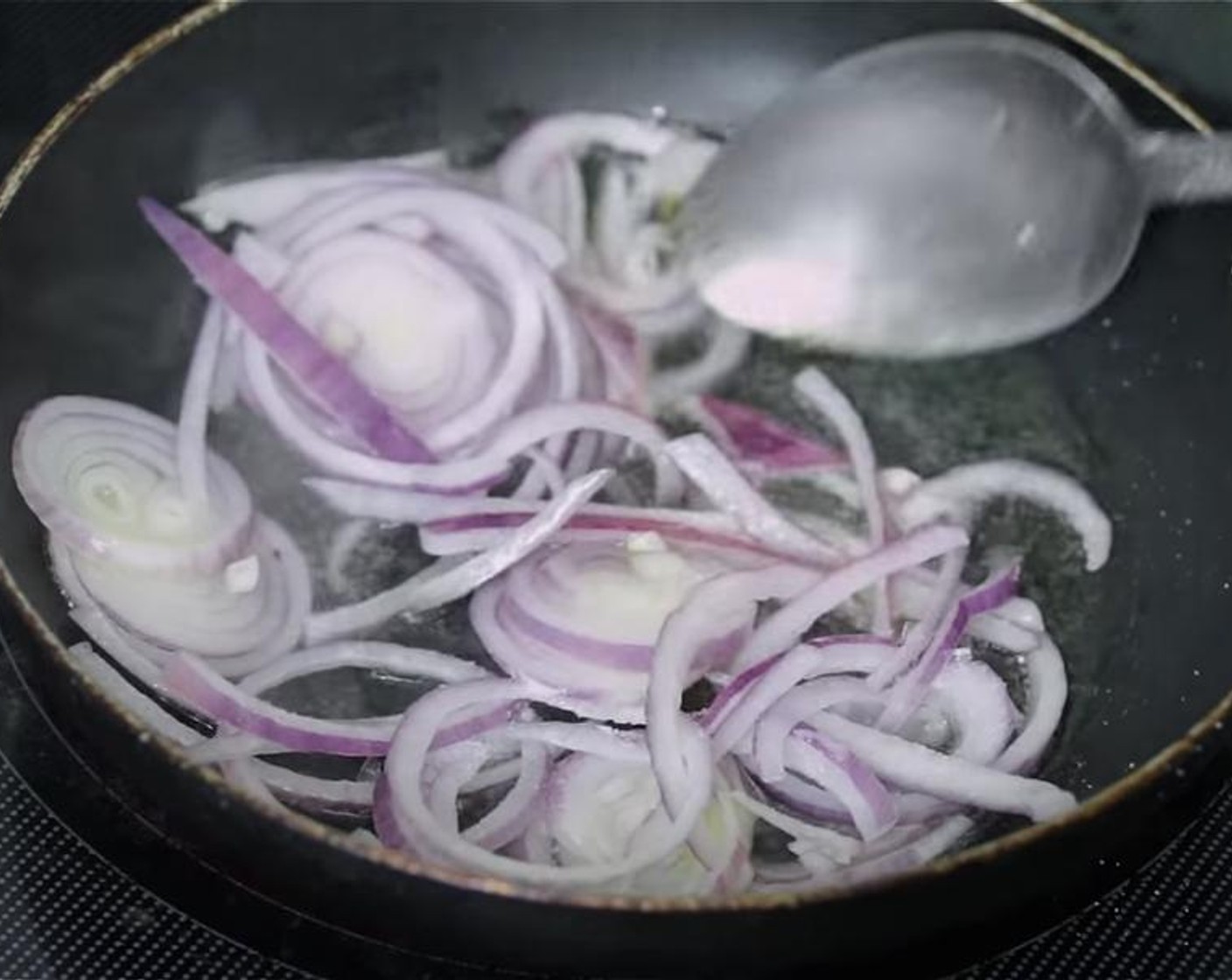 step 6 To fry the onion, in a skillet over medium high heat, add Cooking Oil (1/2 cup) and let it get warm, add sliced Red Onion (1), Distilled White Vinegar (1 Tbsp) and Salt (1/4 tsp), stir and cook for 2 to 3 minutes until it softens a little.