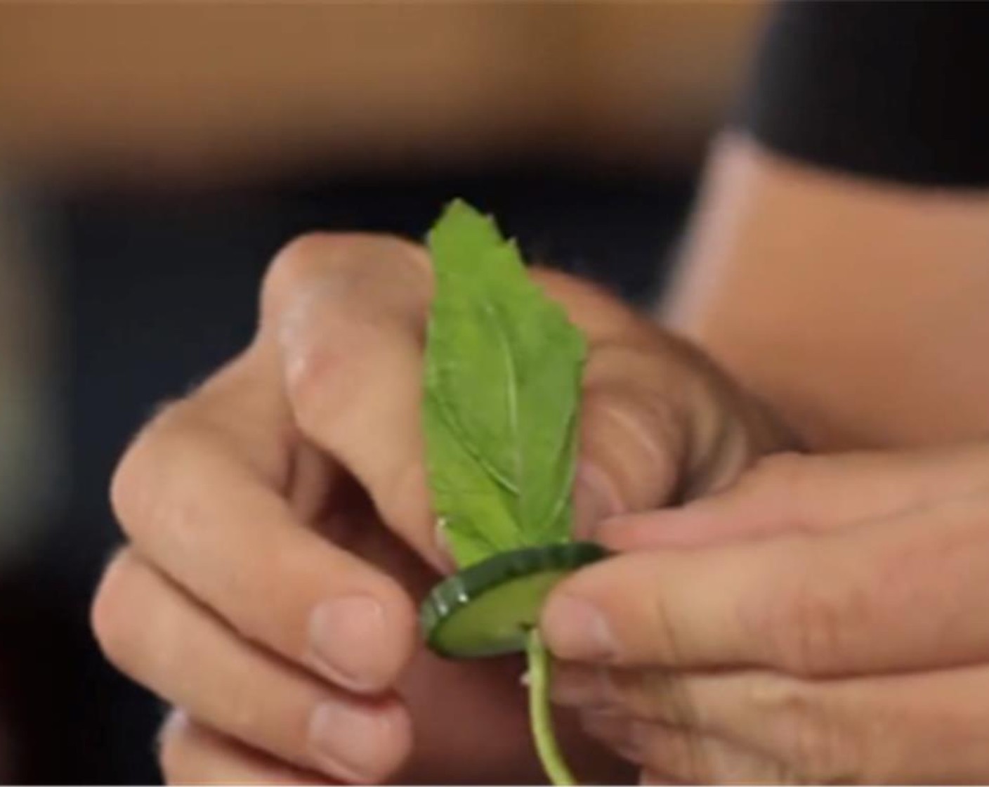 step 3 To garnish stick one sprig of mint through the center of a cucumber.