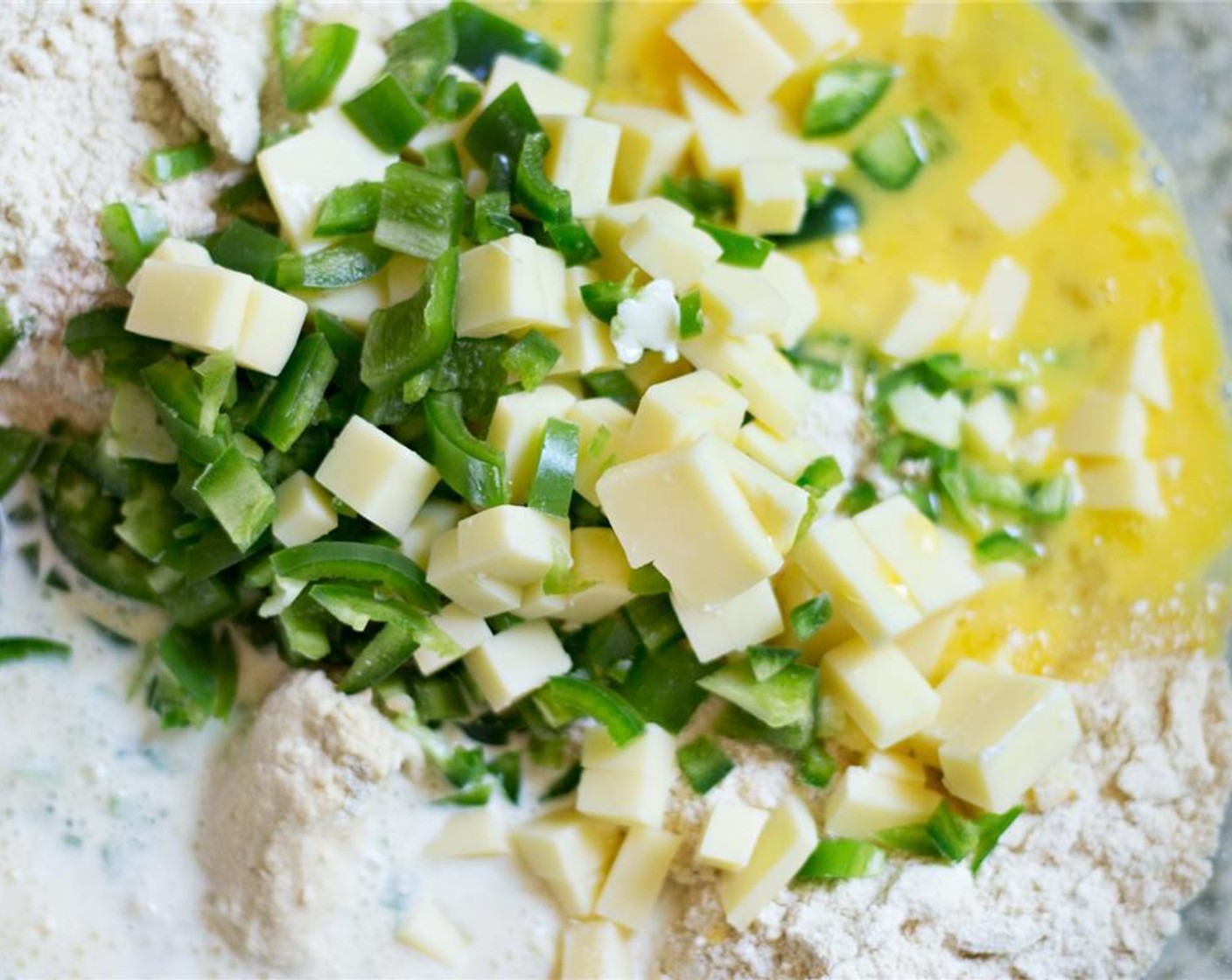 step 7 Add the jalapeno, cheese, Eggs (2), and Milk (1/2 cup) to the bowl, then use your hands to gently mix everything until it just comes together.