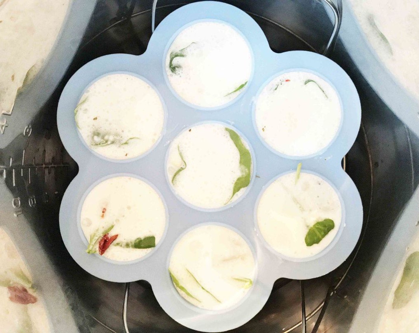 step 7 Place the egg mold onto the metal steamer rack and lower into the pressure cooker.