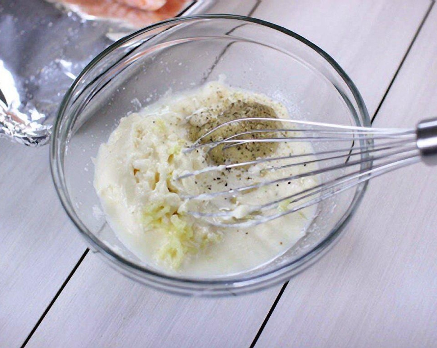 step 4 In a small bowl, combine the Mayonnaise (1/4 cup), juice from Lemon (1), Dijon Mustard (1/2 Tbsp), and Garlic (1 clove). The mixture should be thin enough to easily spread over the onions.