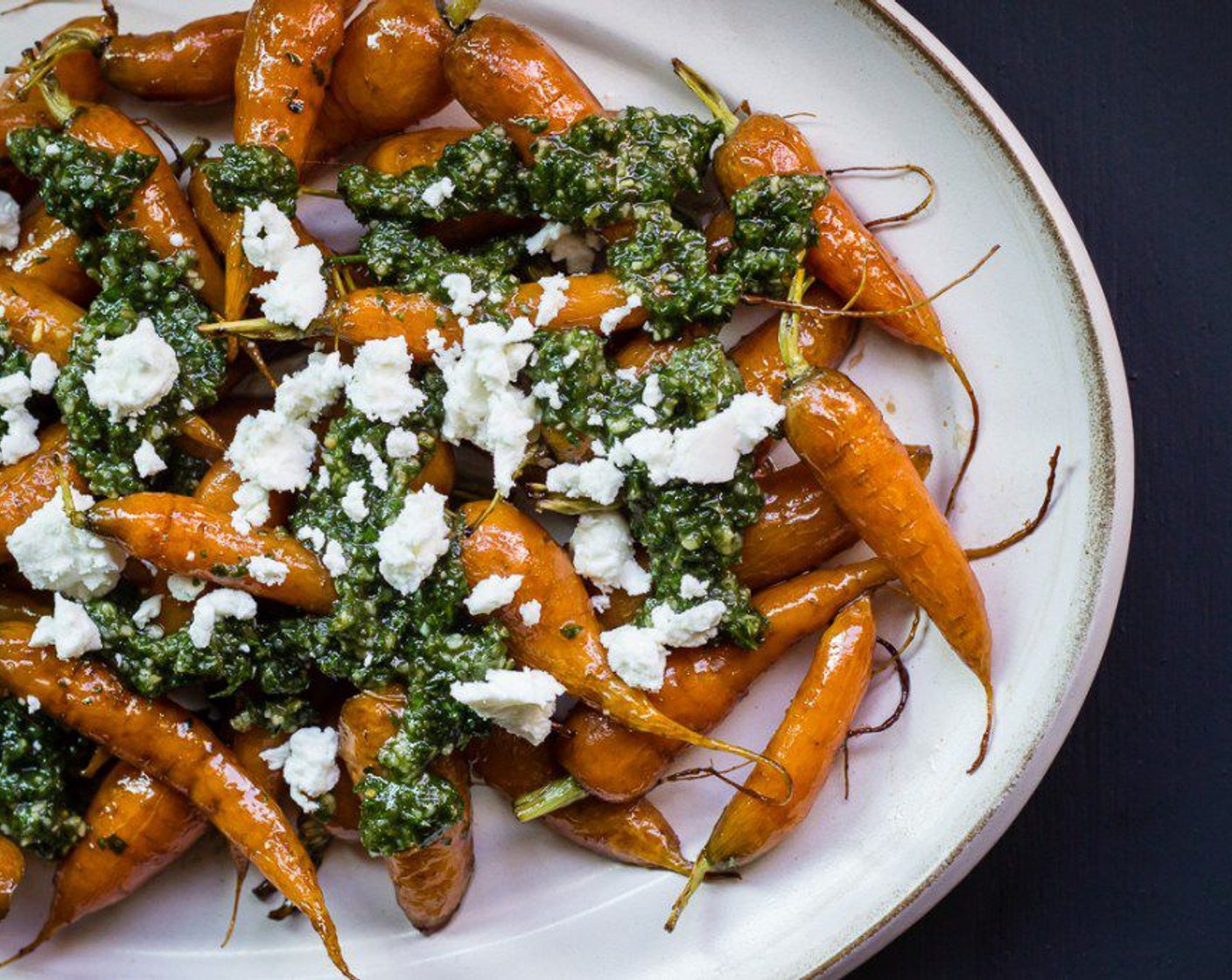 step 10 Place carrots on a serving dish, top with spoonfuls of pesto and then add Goat Cheese (to taste).