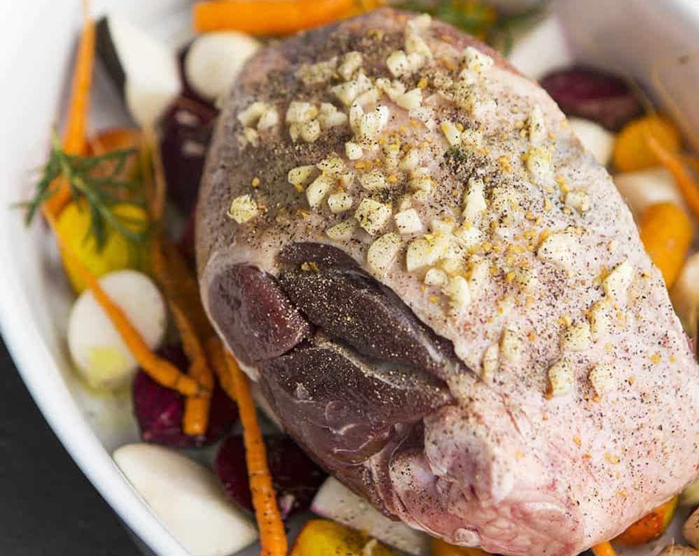 step 4 Arrange the seasoned leg of lamb on top of the vegetables.