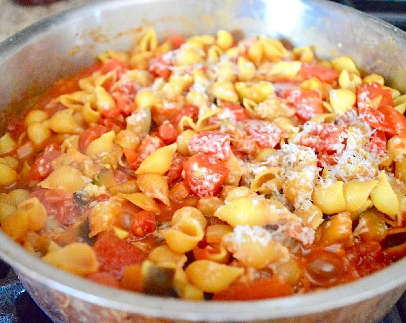 step 5 Let the sauce come to a low simmer and stir in the Medium Pasta Shells (8 oz). Sprinkle the Parmesan Cheese (1/4 cup) on top and transfer the pan to the oven for to bake for about 20 minutes.