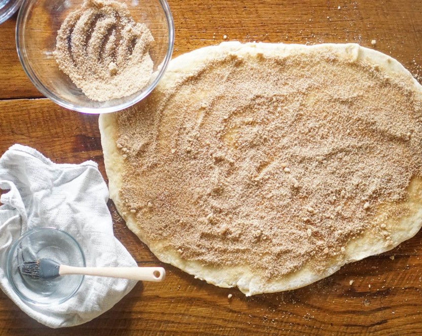step 9 Combine the Brown Sugar (3/4 cup), Granulated Sugar (2 Tbsp) and Ground Cinnamon (1/2 Tbsp) and mix. Evenly brush the Vegan Butter (1/4 cup) over the entire surface of the dough. Evenly sprinkle the sugar mix on top.