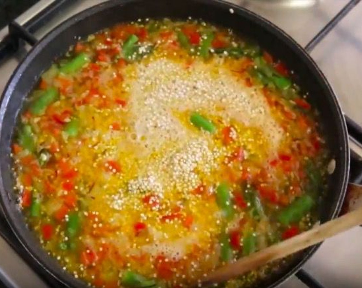 step 9 Bring the mixture to a boil, then add the Quinoa (1 cup) and evenly distribute it with a wooden spoon. Place a lid on the pan and decrease the temperature to a low-medium heat. Cook for about 10 minutes, or until there is no broth left in the pan.