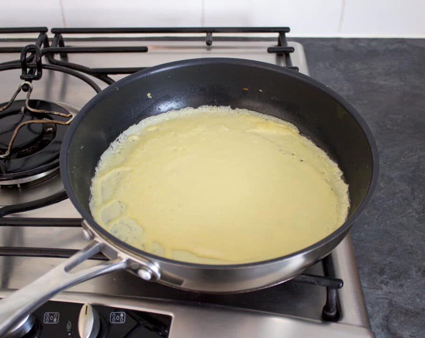 step 6 Pour in roughly 100ml of batter. Immediately swirl the mixture around the pan to even it out. This needs to be done very quickly, or you will end up with thin & thick parts.
