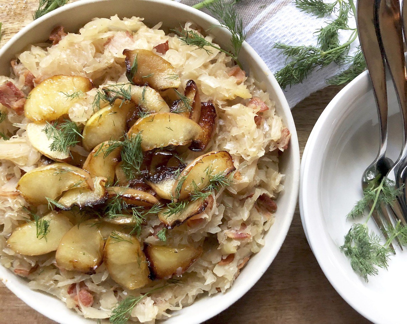 step 5 Core and slice the Fuji Apple (1).  Melt Salted Butter (2 Tbsp) in small saucepan over medium heat. Add the apple slices and sauté until just softened and lightly caramelized on the edges. Sprinkle over sauerkraut dish with the snipped fresh dill weed. Enjoy!