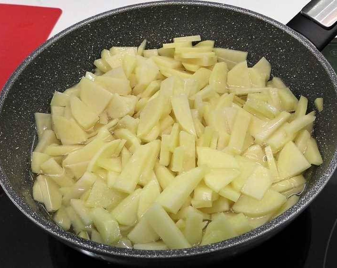 step 1 Start by peeling, cleaning, and cutting the Potatoes (3). Season with Salt (to taste) and begin to cook them in a pan with enough Olive Oil (as needed) to almost cover them.