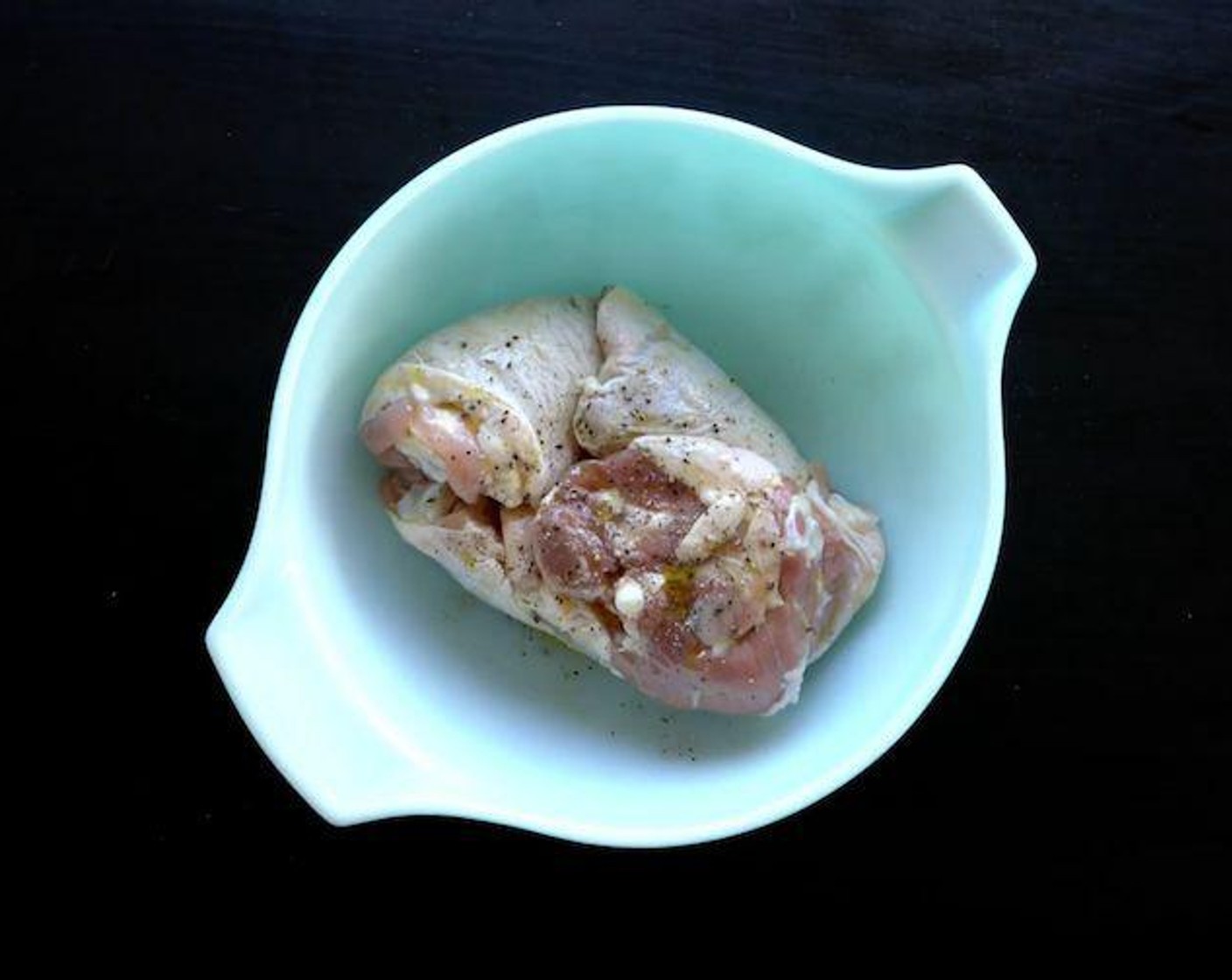 step 2 In a bowl, mix the Bone-In Chicken Thighs (6), Olive Oil (1/4 cup), Herbes de Provence (2 Tbsp), and Ground Black Pepper (1 tsp).