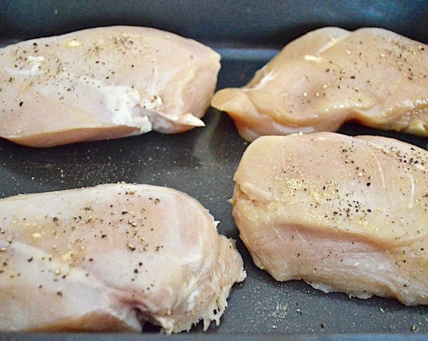 step 2 Place the Boneless, Skinless Chicken Breasts (4) in a 9x13-inch casserole dish and season it generously with the Salt (3 pinches), Ground Black Pepper (3 pinches), and McCormick® Garlic Powder (3 pinches).