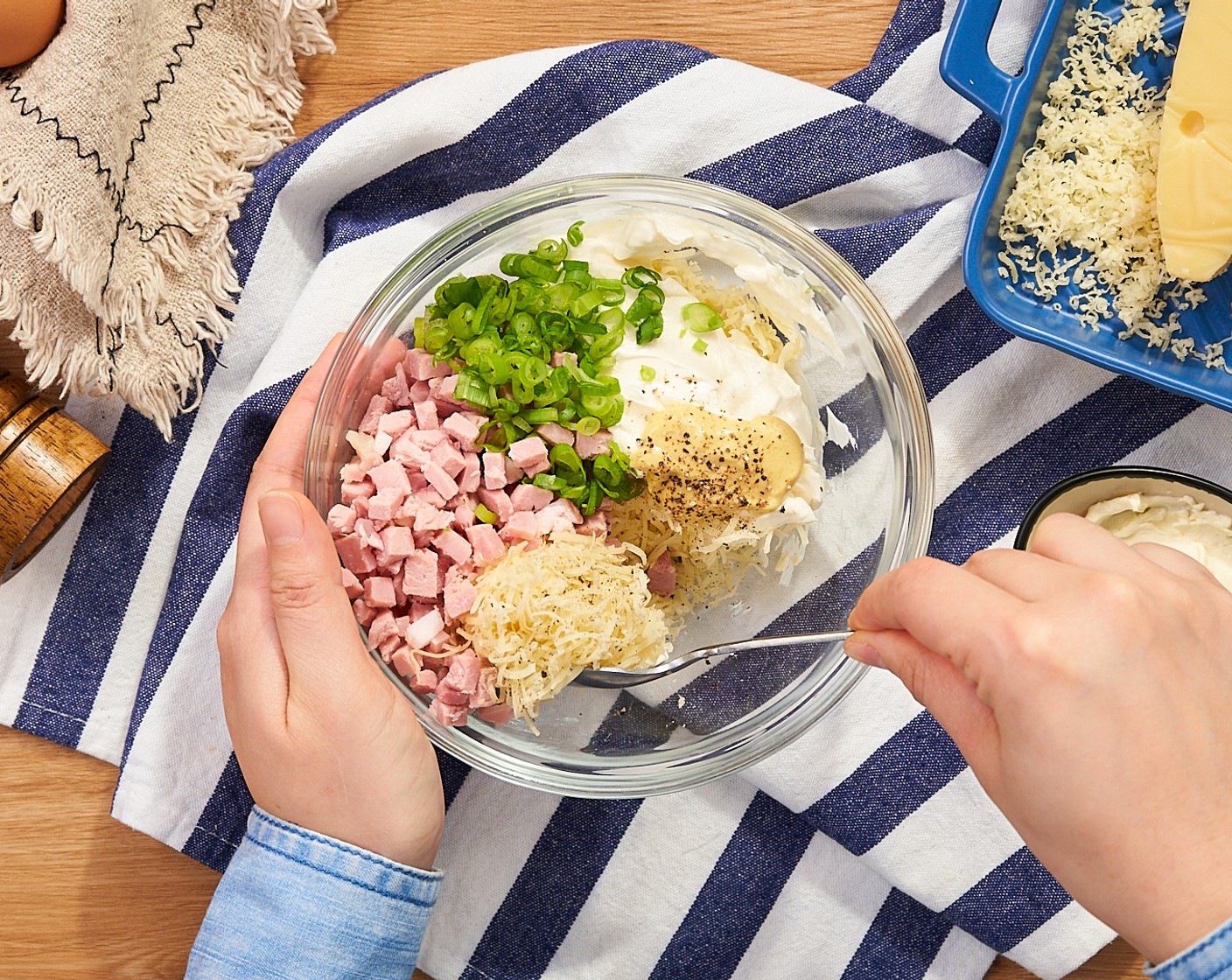 step 3 In a medium mixing bowl, combine the Cooked Ham (3 oz), Swiss Cheese (3/4 cup), Cream Cheese (1/2 cup), Scallion (1 stalk), Dijon Mustard (1/2 Tbsp), and Ground Black Pepper (to taste) together. Set aside.