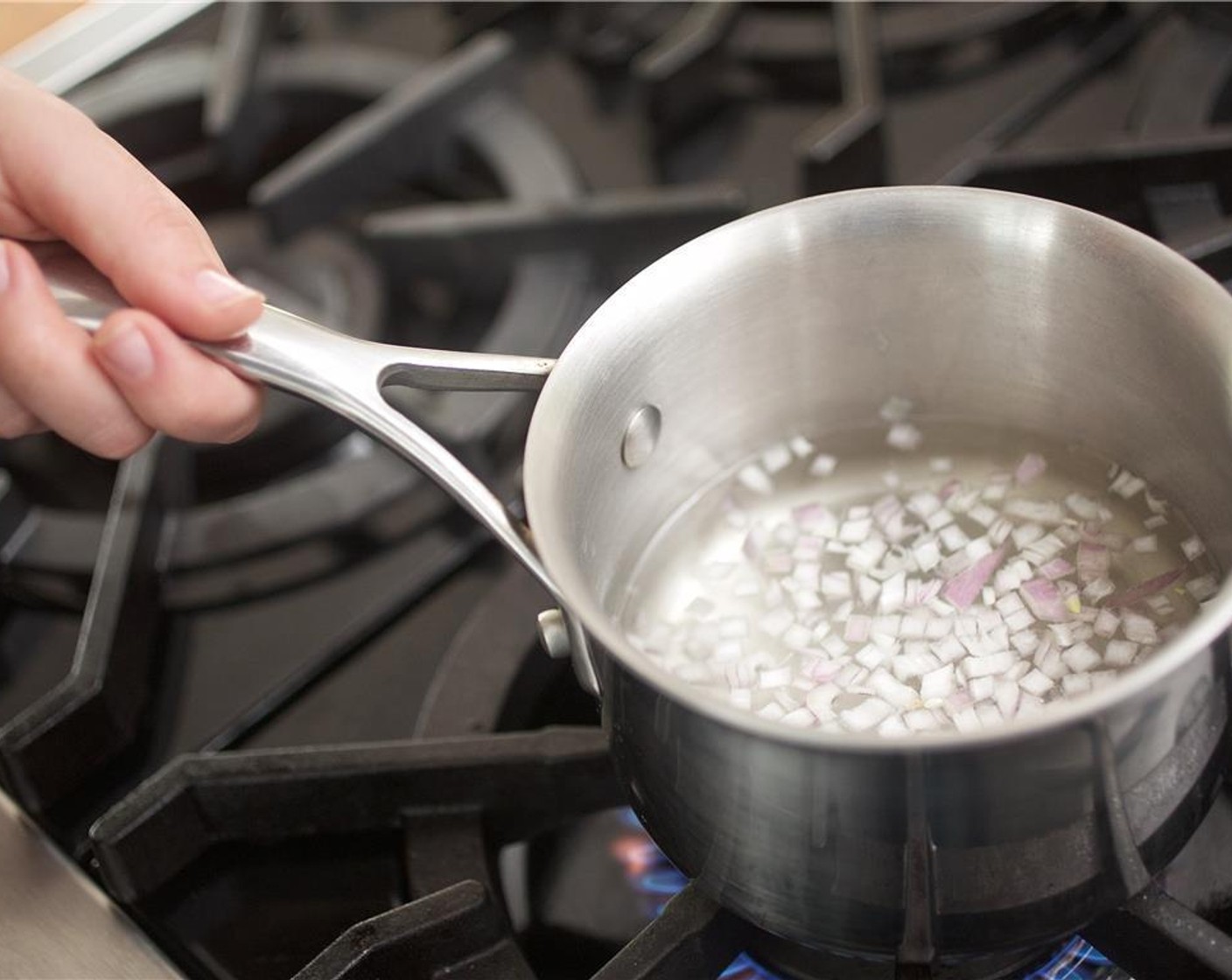 step 6 Meanwhile, bring a small saucepan with one cup of water to a boil. Add shallots and cook for twenty seconds. Strain and toss with one tablespoon of Champagne Vinegar (1 Tbsp).