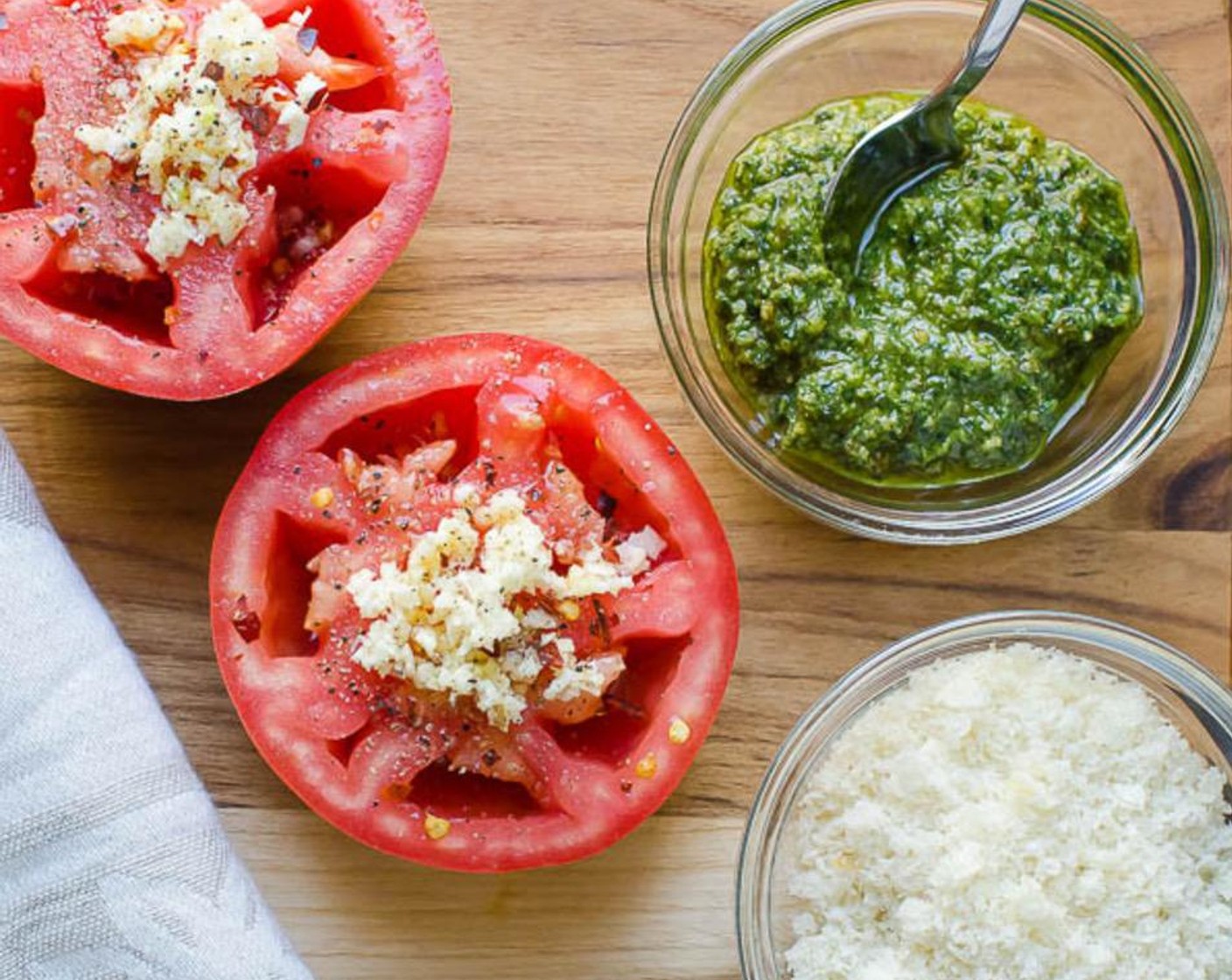 step 3 Divide the Garlic (2 cloves) between the tomato halves and sprinkle a very small pinch of Crushed Red Pepper Flakes (1 pinch), Salt (1/2 tsp), and Ground Black Pepper (1/2 tsp) onto each tomato.