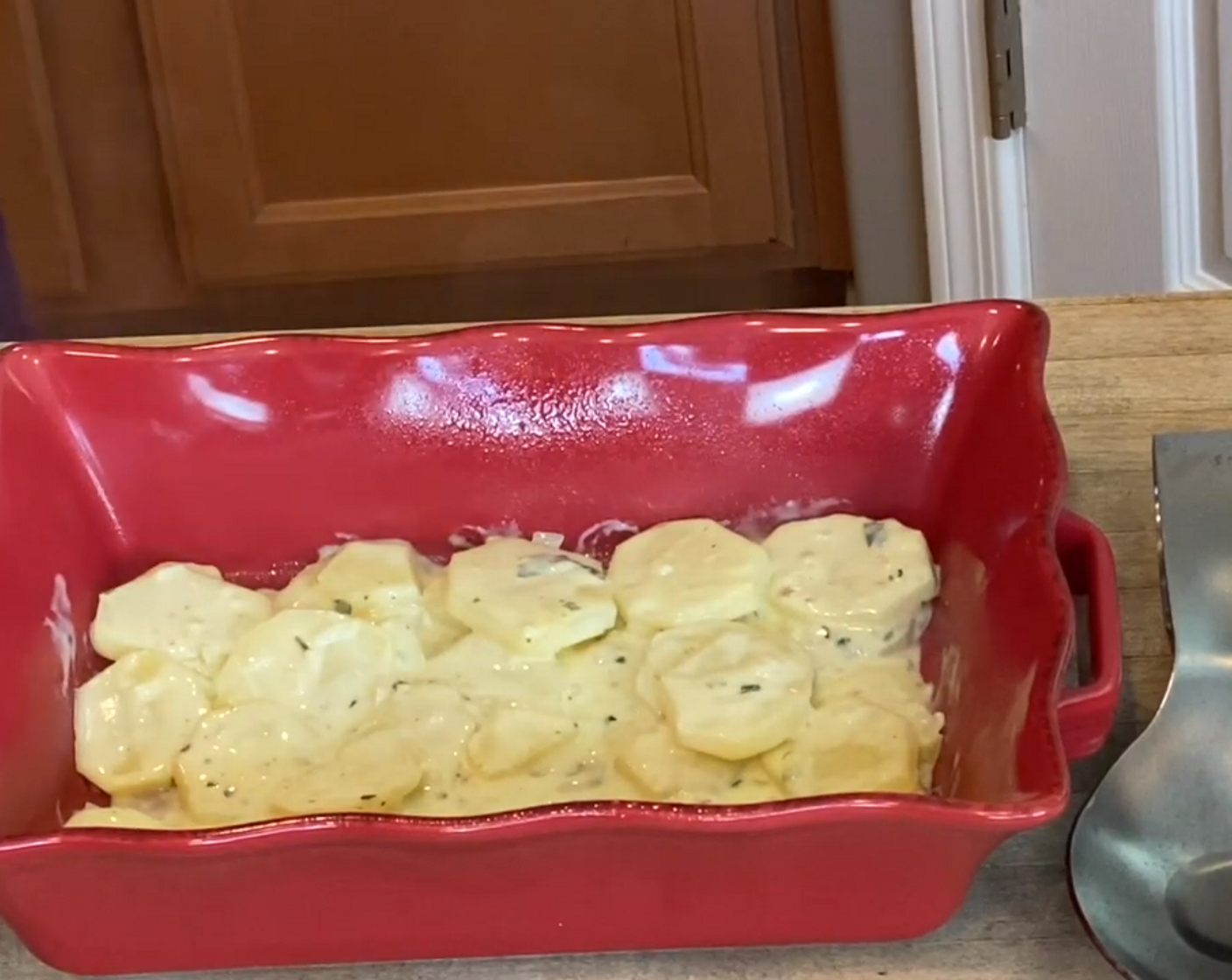 step 6 Spoon half of the potatoes into a lightly greased baking dish, making sure to create a flat layer.