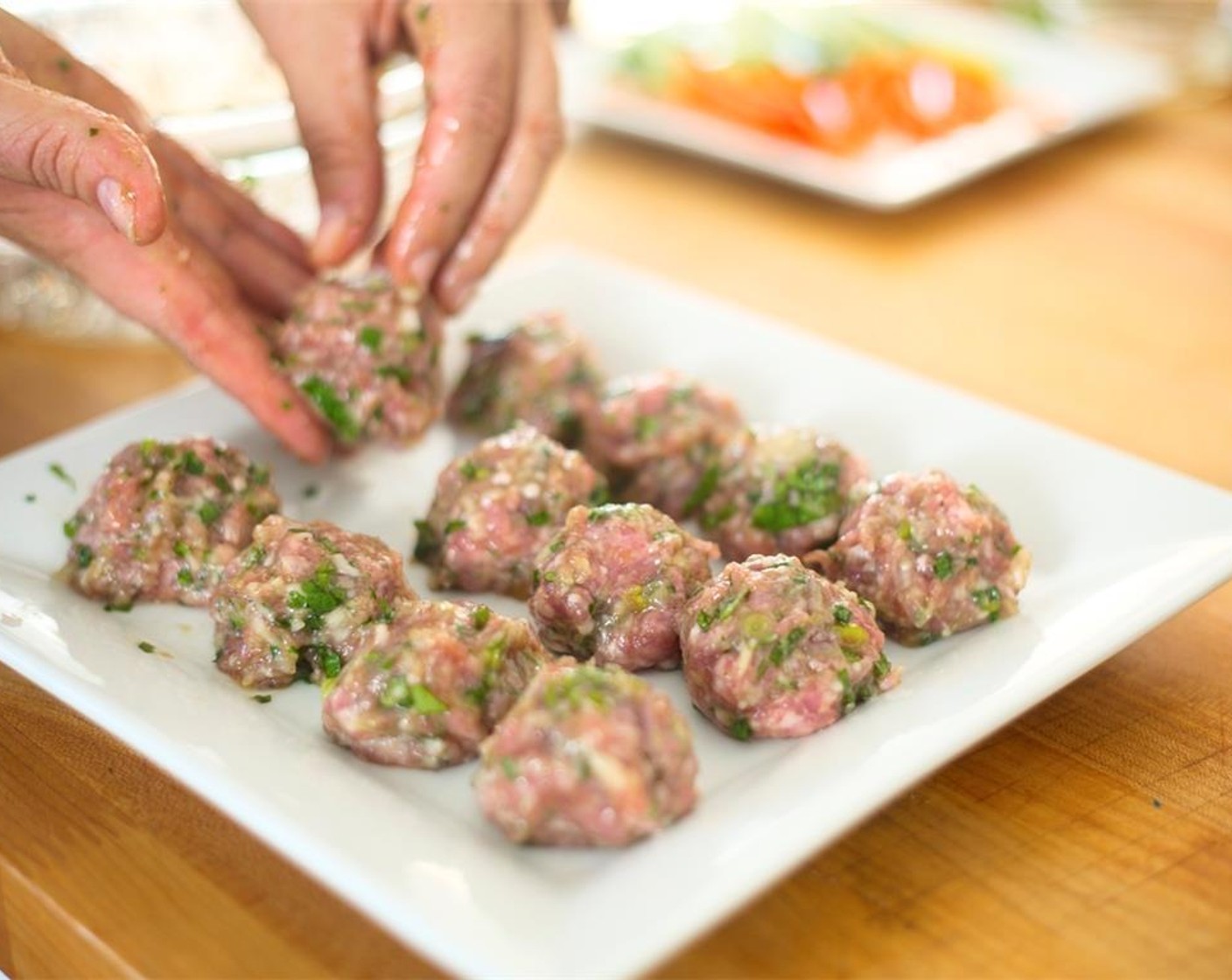 step 7 Mix well and then gently fold in Ground Pork (12 oz) Roll twelve small meatballs of equal size. Place on a plate and put in freezer for fifteen minutes.