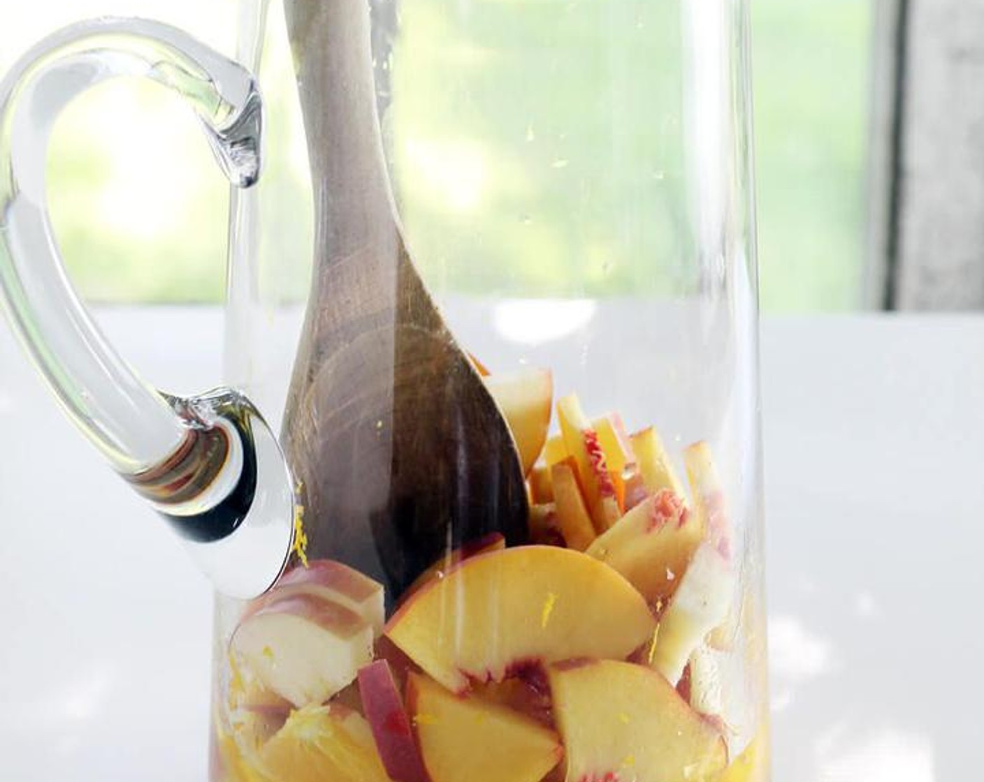 step 4 Pour the orange juice and zest into a large pitcher. Layer the fruit pieces on top. With a spoon, gently muddle the fruit.