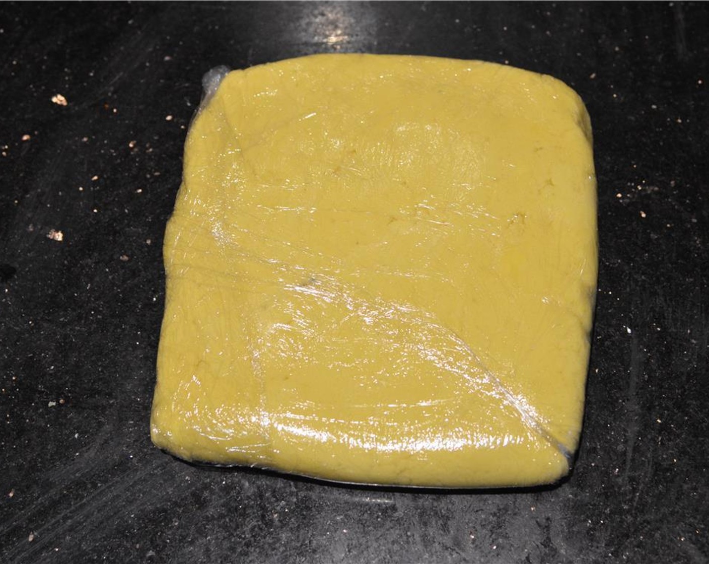 step 4 Place dough on a piece of plastic wrap and form into a flat square. Cover with another film of plastic and refrigerate for at least 1½ hours.