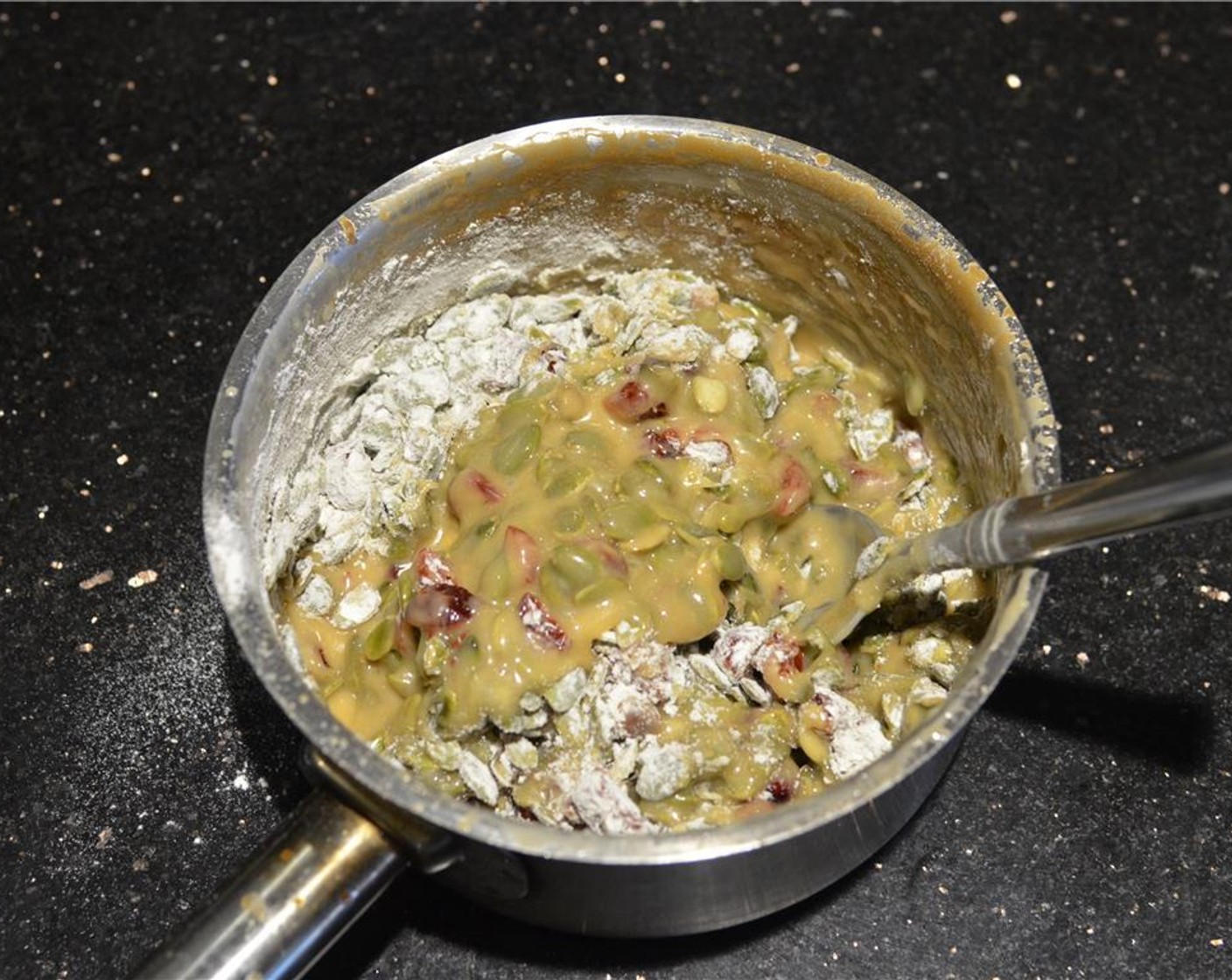 step 7 While the cookie dough is baking, mix together the Pepitas (1 1/3 cups), Dried Cranberries (3/4 cup), zest of the Orange (1) and Cake Flour (1/3 cup) in a small bowl and set aside.