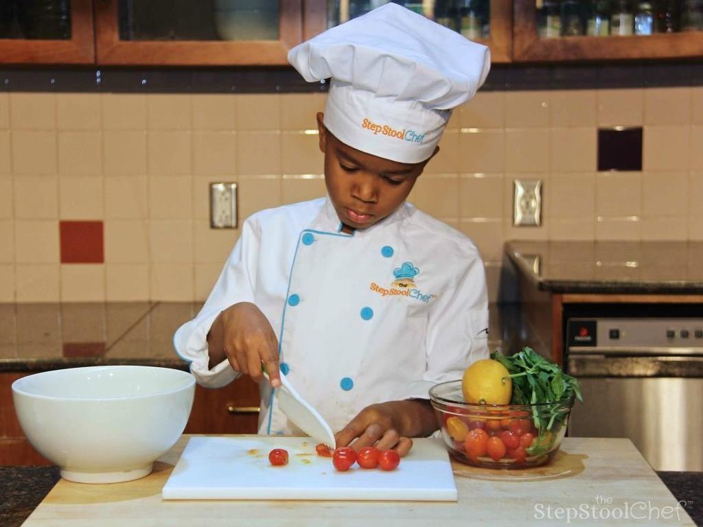 Step 7 of Italian Baked Tilapia Parmesan & Basil Pesto Rice Recipe: While the fish is in the oven, start the bruschetta topping.  First, cut the Cherry Tomato (1 pint) into quarters by cutting them in half then half again.