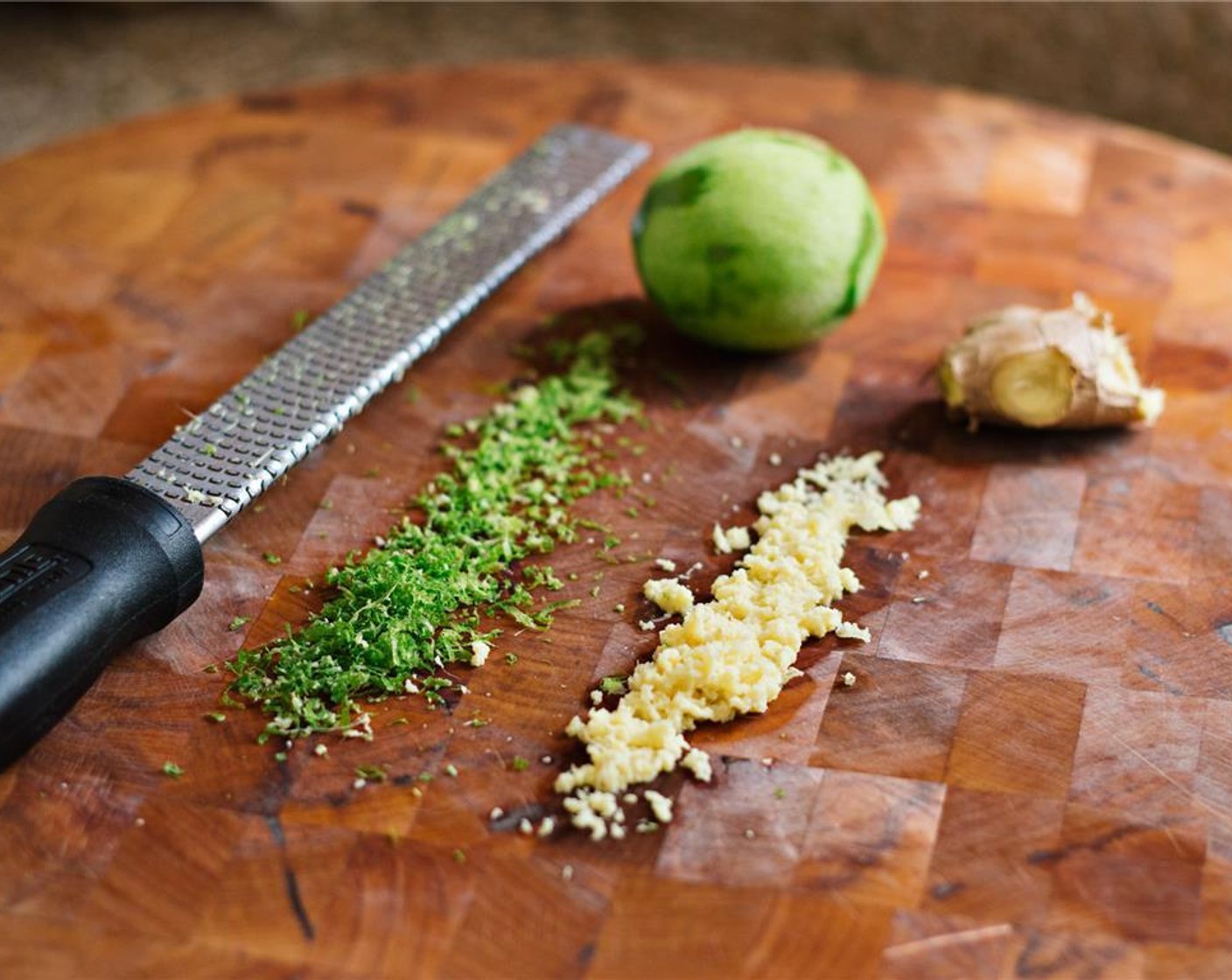 step 2 While the couscous cooks, grate the Fresh Ginger (1) and zest the Lime (1) with a microplane grater. Whisk the ginger, lime zest, Agave Syrup (1 tsp), Grapeseed Oil (1/4 cup), and lime juice together in a small bowl. Add Salt (1/4 tsp) and Ground Black Pepper (1/4 tsp).