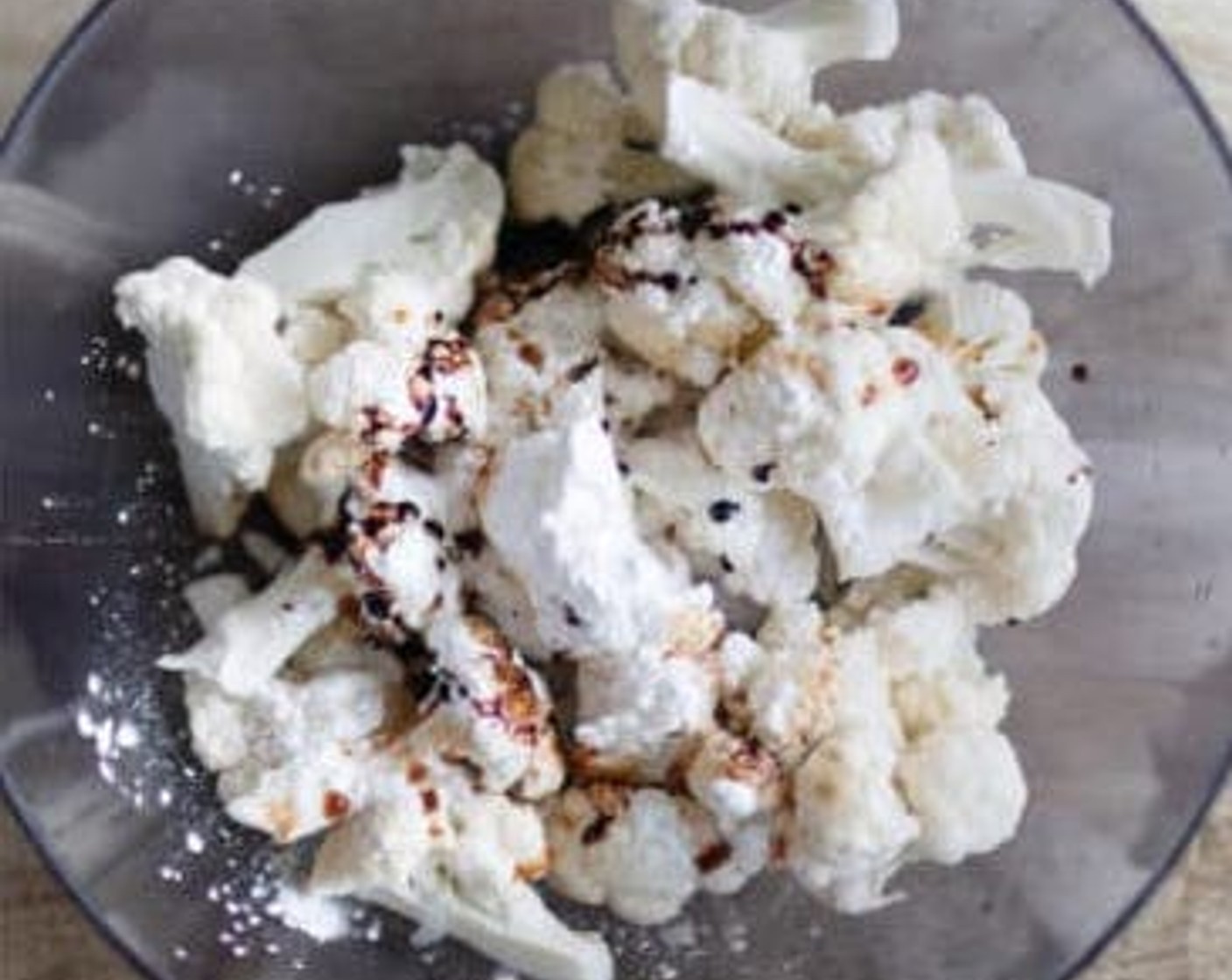 step 2 Put the florets in a large mixing bowl, adding Corn Starch (1 Tbsp), and Dark Soy Sauce (1 Tbsp). Mix well, making sure each cauliflower floret is coated evenly.