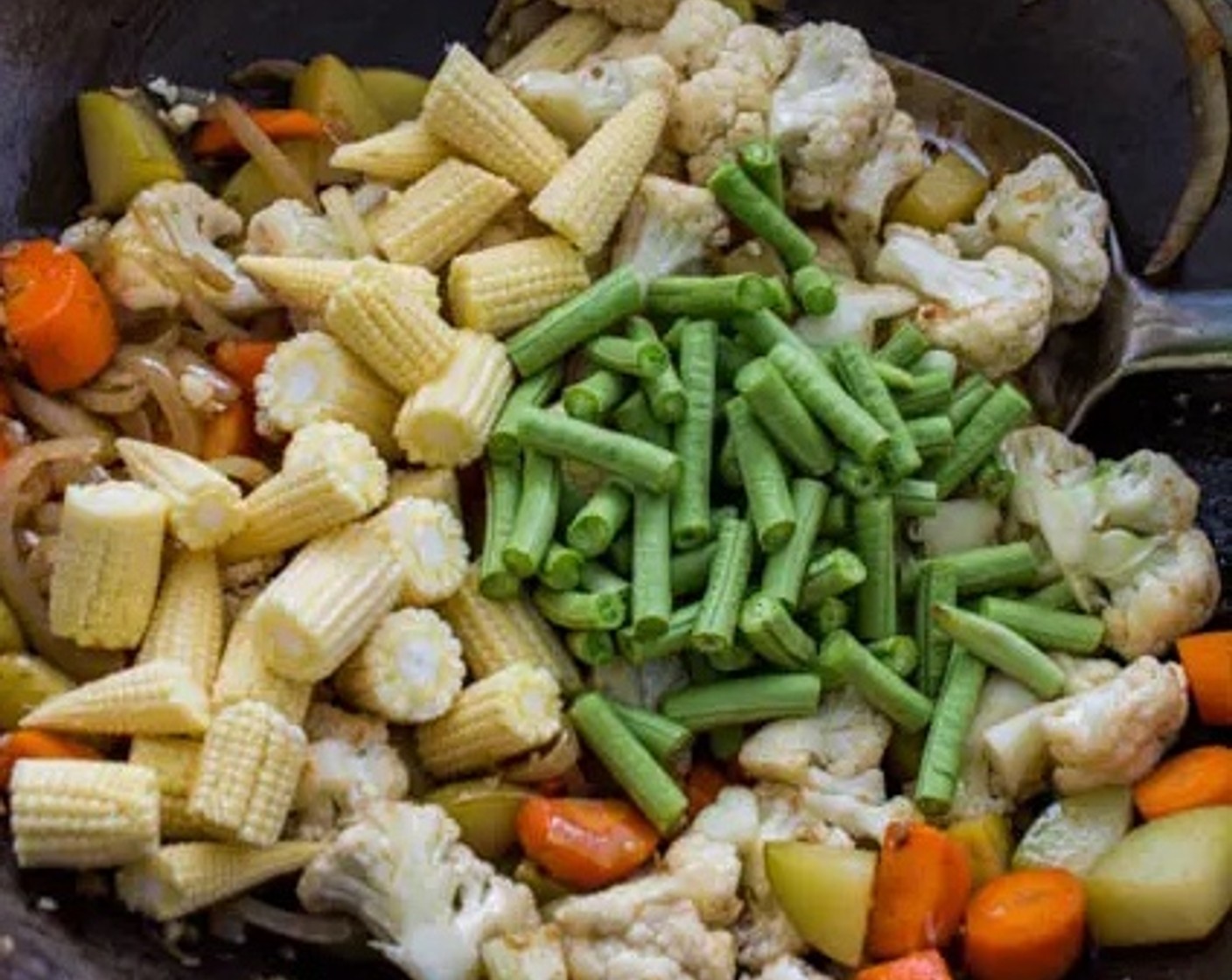 step 4 Toss in Green Beans (1 cup) and Baby Corn (1 1/2 cups) to the wok. Pour 2 Tbsp of water into the wok to help steam the vegetables.