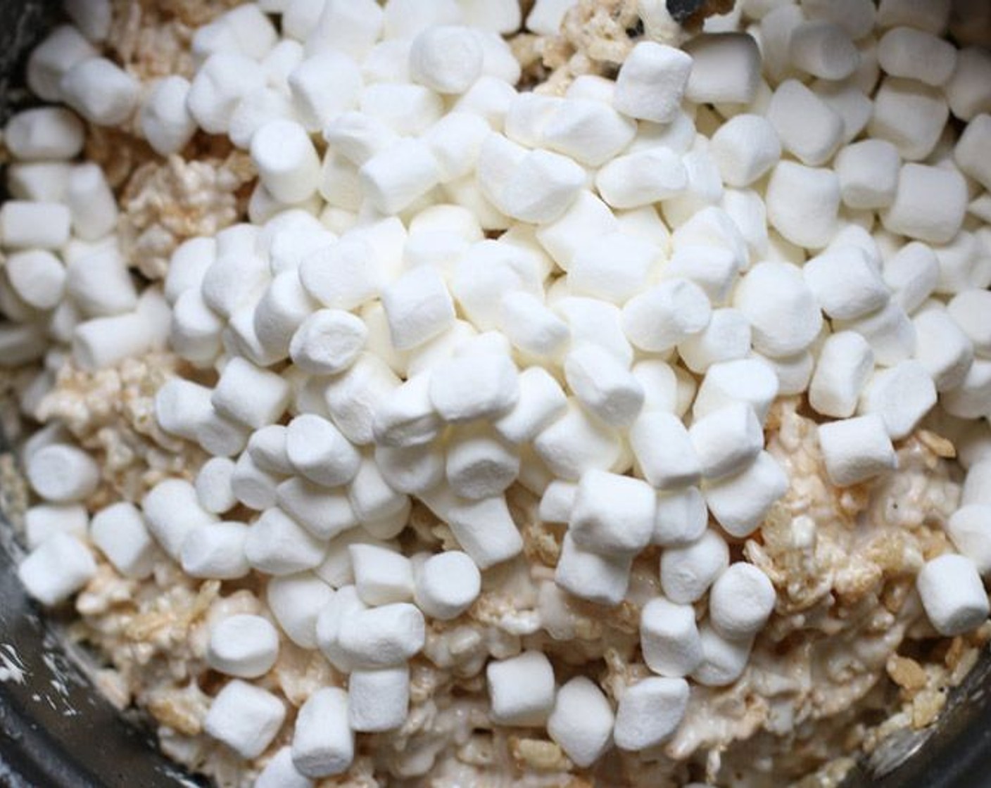 step 3 With a wooden spoon, stir in the Rice Krispies® Cereal (12 cups) and mix until the cereal is evenly coated. Then stir in the remaining Mini Marshmallows (4 cups).