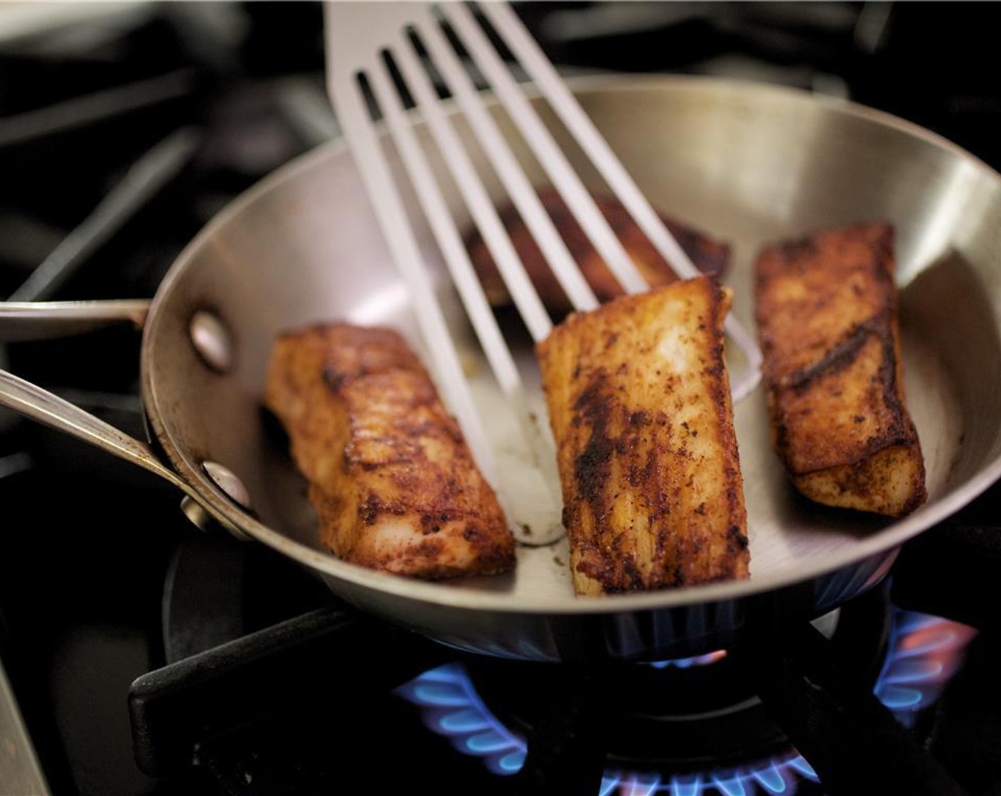 step 14 In another medium bowl, coat fish with Vegetable Oil (1/4 tsp) on both sides. Season with Ancho Chili Powder (1 tsp), Salt (1/4 tsp), and Ground Black Pepper (1/4 tsp).