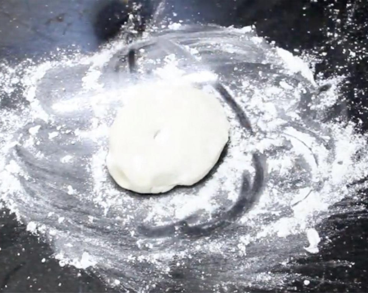 step 8 Transfer one ball of dough into the work surface covered with flour. Dust extra flour on top.