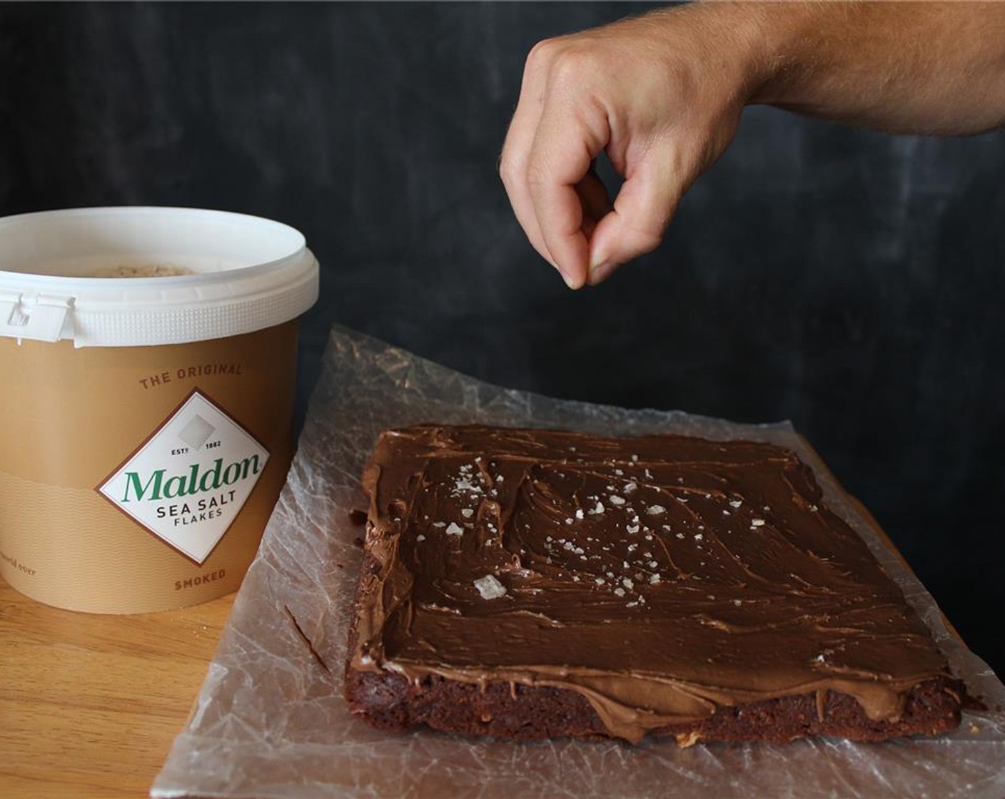 step 12 Either frost the brownies in the pan or invert the pan onto a serving platter and then frost them. As soon as you've finished spreading the frosting, immediately sprinkle the Smoked Sea Salt Flakes (1 tsp) evenly atop the frosting.