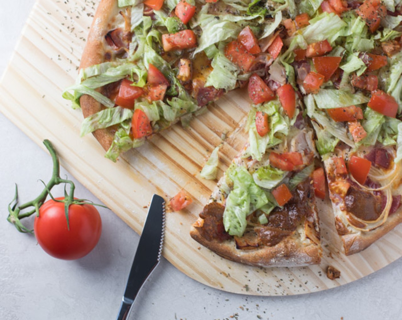 step 7 Once the pizza is done baking, top with Lettuce (2 cups) and Tomato (1). Lightly sprinkle with Italian Seasoning (1/2 tsp) and drizzle your favorite Italian Dressing (1/4 cup) on top.