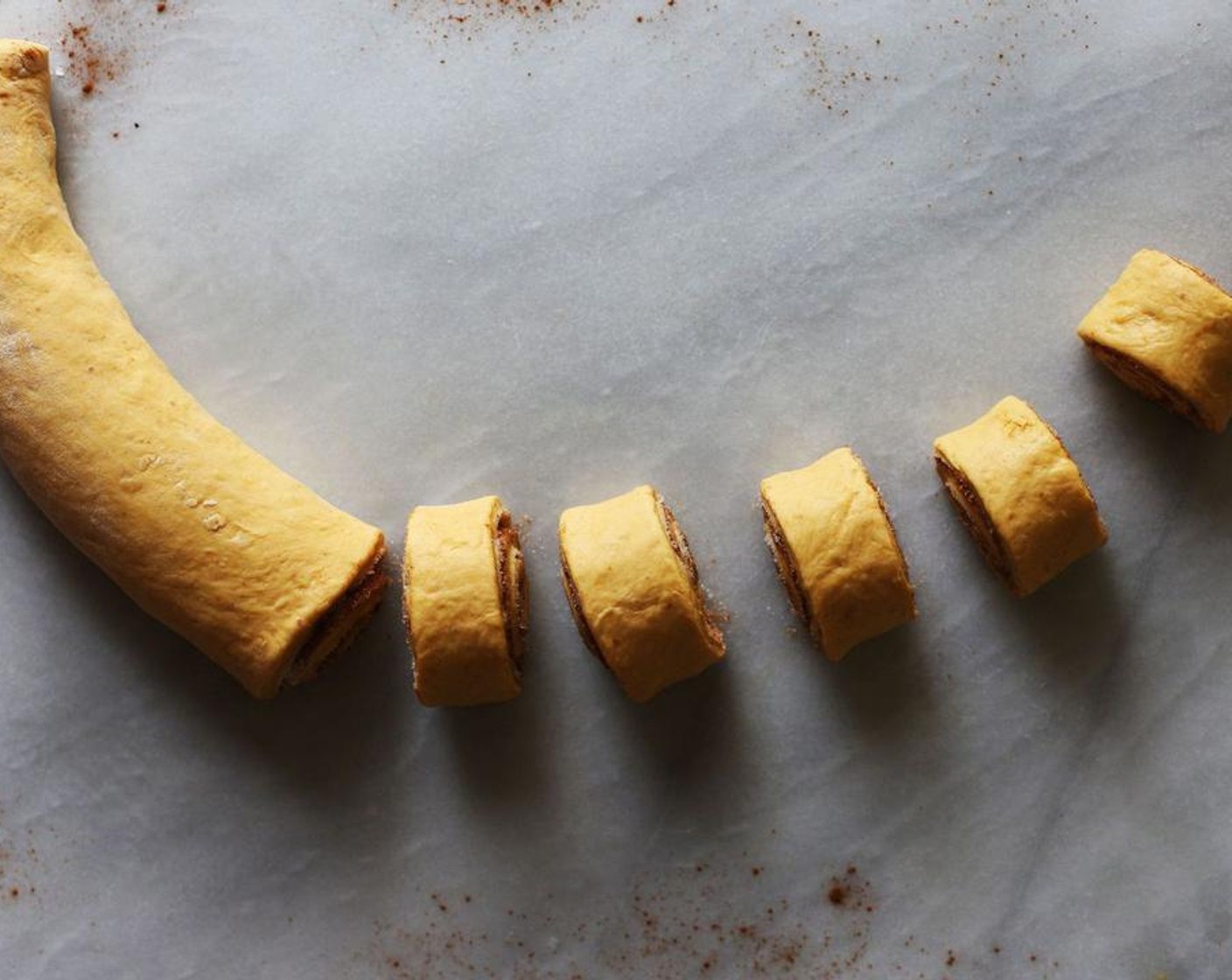 step 11 Cut the dough into 1-inch rolls and place it into a dish greased with Non-Stick Baking Spray (as needed). Set aside to rise for another 15 minutes. Roll out the other half of the dough with the other half of the Butter (1/4 cup) and repeat the process.