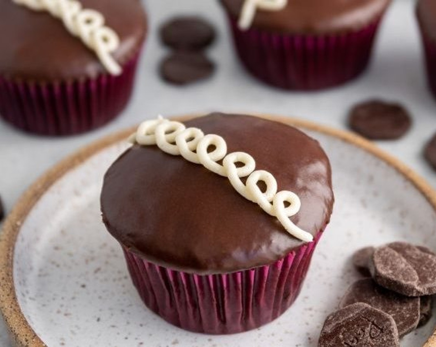 step 19 Spoon the leftover meringue buttercream into a piping bag fitted with a small tip, pipe swirls across the center of each cupcake for that Hostess look. Enjoy!