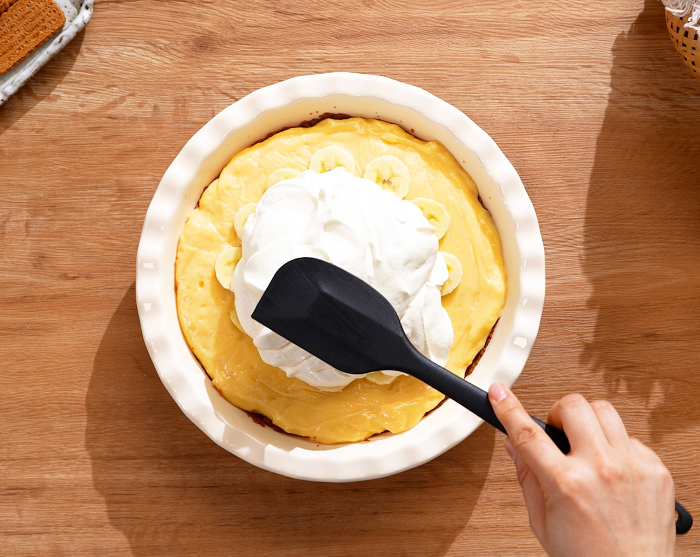 step 11 Layer the rest of the banana slices on top of the filling. Spread the whipped cream on top and refrigerate for about 4 hours until set.