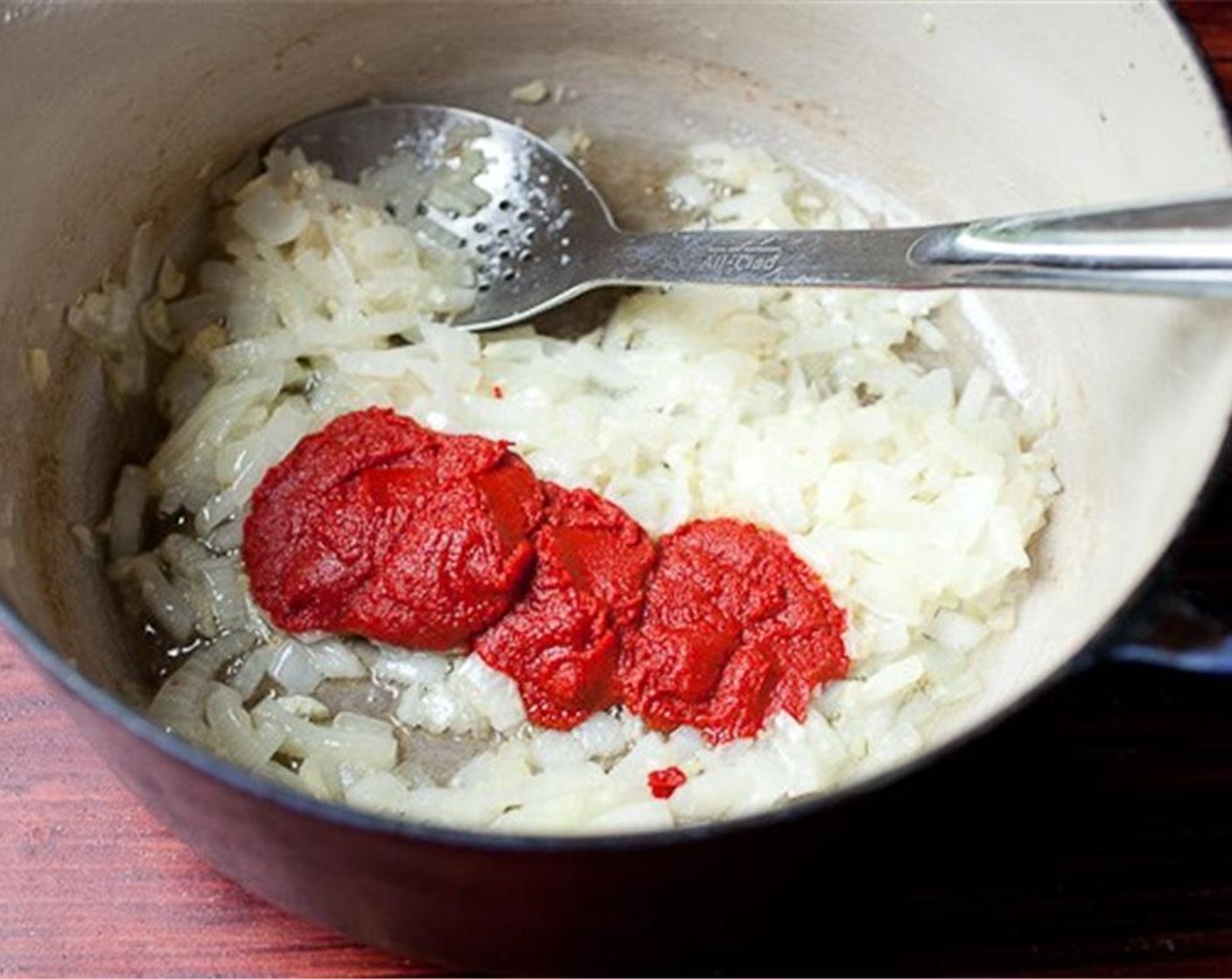 step 3 Add Tomato Paste (4 Tbsp) and Chicken Stock (2 cups) to the pot and bring the mixture to a simmer.