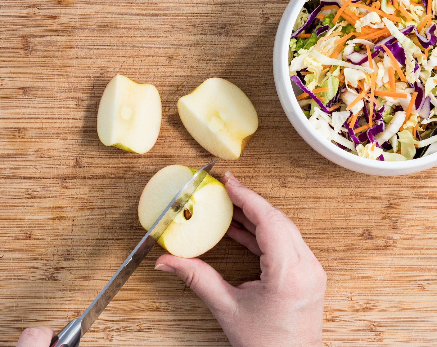 step 4 While the meatballs cook, assemble the rainbow slaw. Core the Red Apple (1) and cut it into matchsticks. Carefully toss with the Coleslaw Mix (1 bag) in a large bowl.