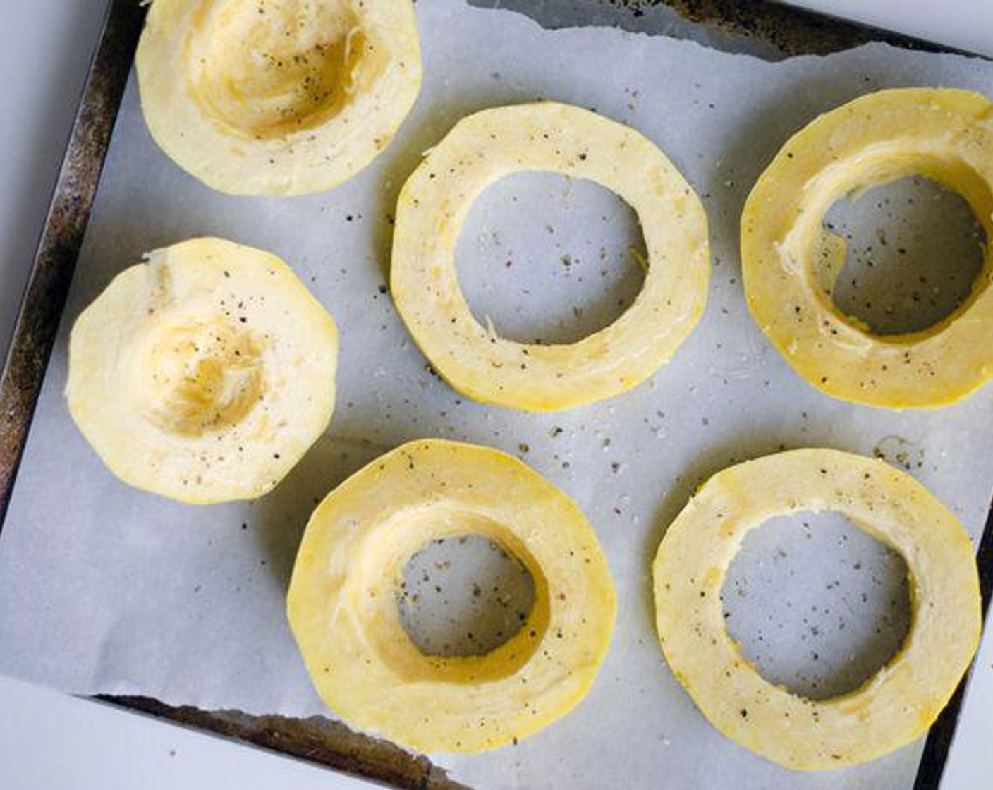 step 2 Set on a parchment paper-lined baking sheet and drizzle both sides with Olive Oil (1 Tbsp) and sprinkle with Salt (1 dash) and Ground Black Pepper (1 dash). Bake about 40 minutes at 400 degrees F (200 degrees C), or until tender.