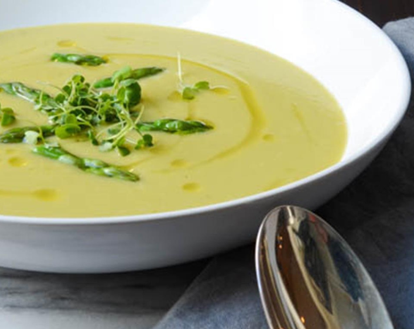 step 10 To serve, ladle the soup into bowls and swirl a teaspoon of olive oil over each bowl. Divide the asparagus tips among the bowls and float them in the soup. Top with a pinch of Microgreens (to taste) if desired.