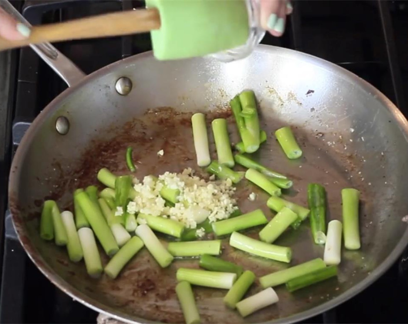 step 8 Add more oil to the pan, along with the scallions whites and garlic.