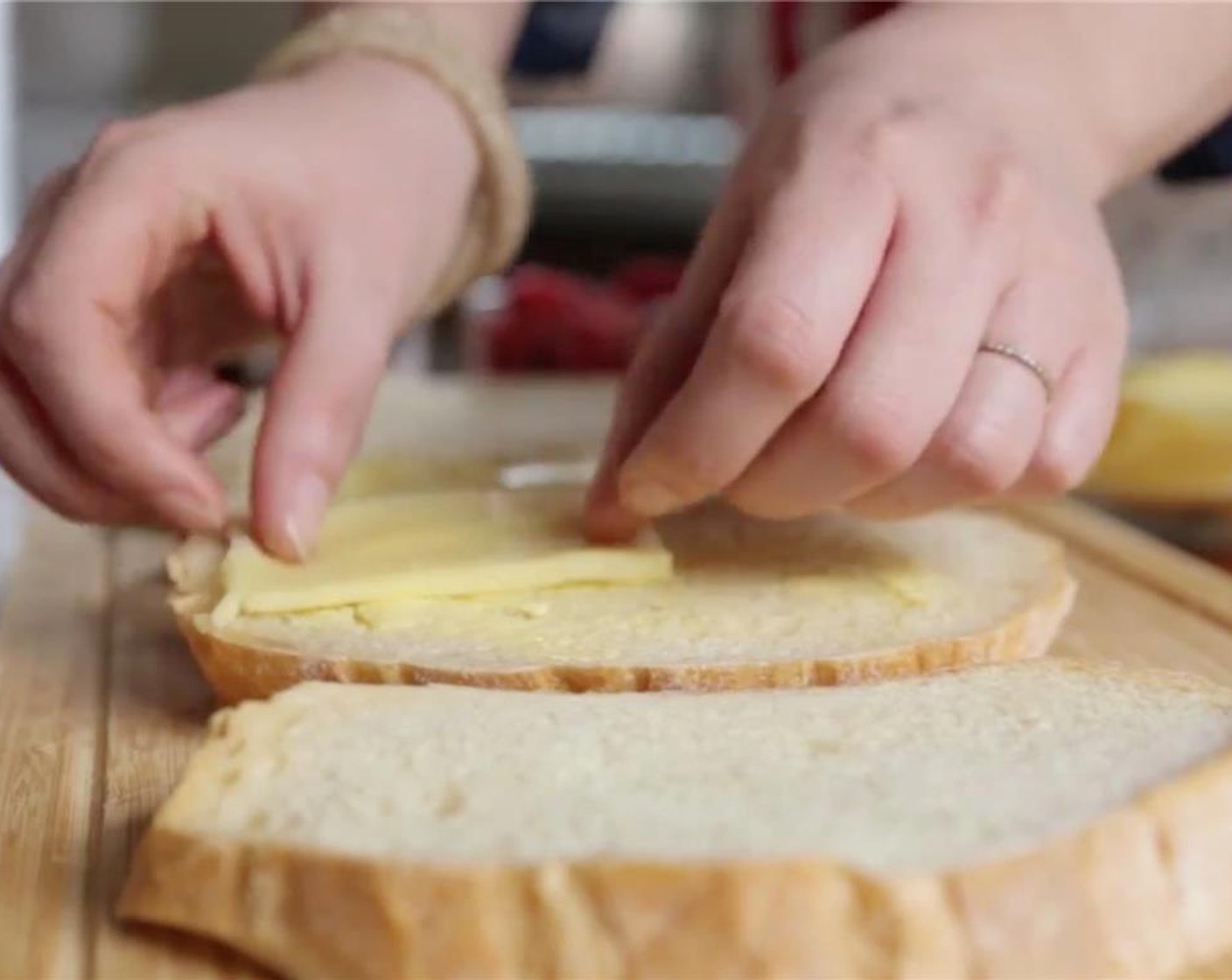 step 3 Place butter side down on the cutting board. Top unbuttered side of the bread with Cheddar Cheese (3 slices).