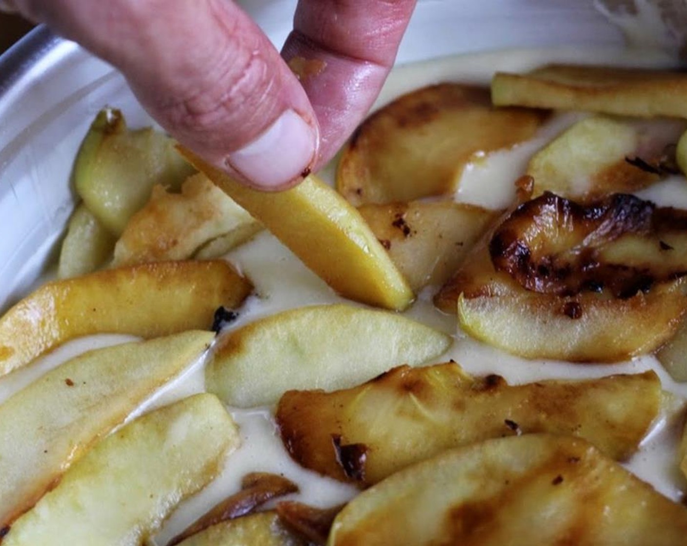 step 8 Transfer batter into a 9-inch spring form pan lined with parchment, or prepared with a natural shortening and floured. Lay apple slices evenly onto cake.