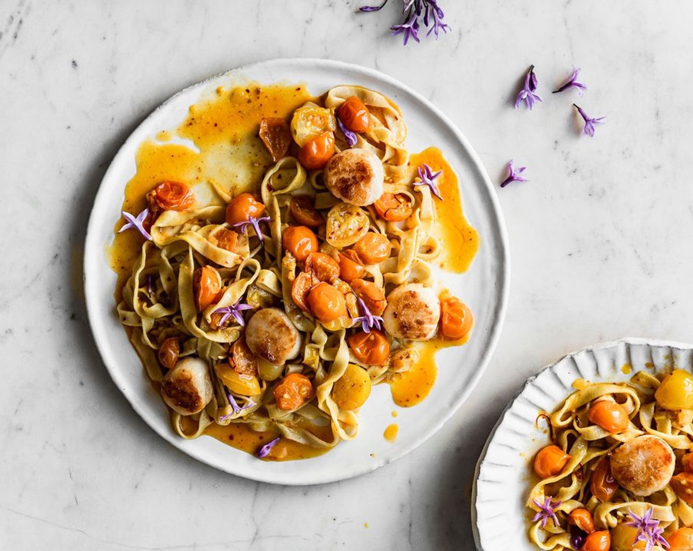 step 8 Serve the pasta topped with scallops & garnish with Society Garlic Blossoms (2 Tbsp).