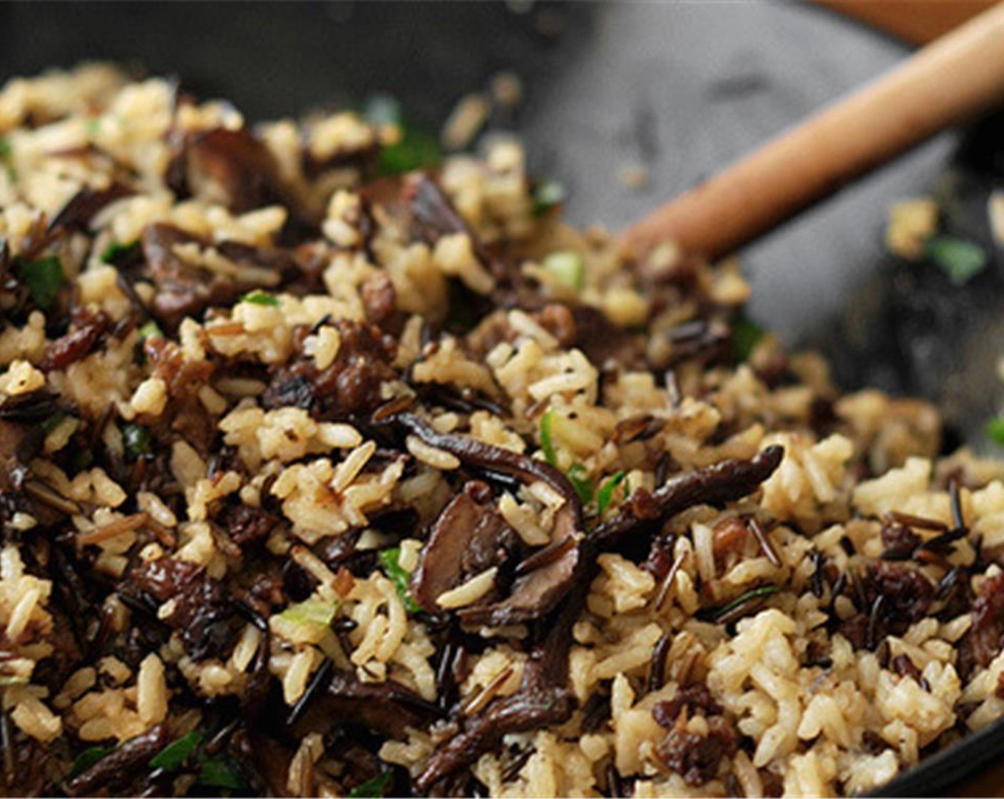 step 11 Fluff up the cooked wild rice and long grain rice and transfer it to a large serving bowl. Add the cooked ground spicy sausage and mushroom mixture and stir until evenly combined.