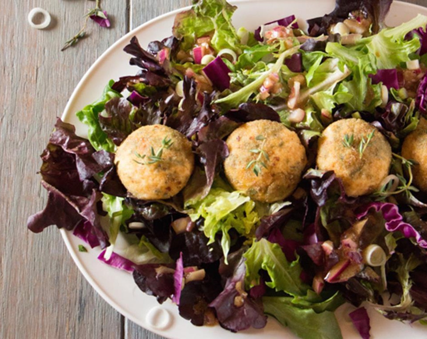 step 13 Divide green salad among individual plates; place as many goat cheese balls and Freshly Ground Black Pepper (to taste) you want and serve.