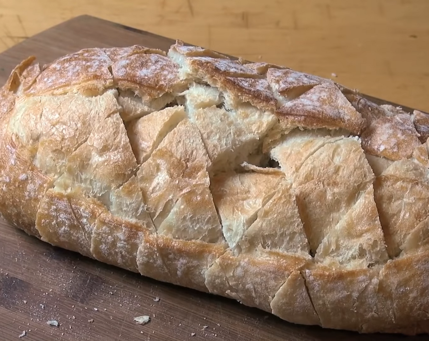 step 4 Turn the bread slightly to do the opposite diagonal. Do not cut all the way through, again slicing around 1-inch apart. There will be diamond-shaped wedges on the loaf but still attached.