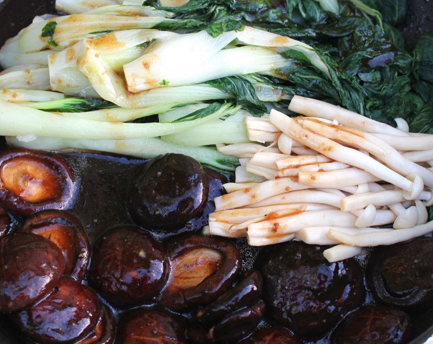 step 12 Bring the mushrooms and sauce to a simmer, then add enough of the cornstarch slurry to lightly thicken. Add the bock choy and seafood mushrooms, and cover all in sauce. Taste and adjust seasonings or texture if needed.