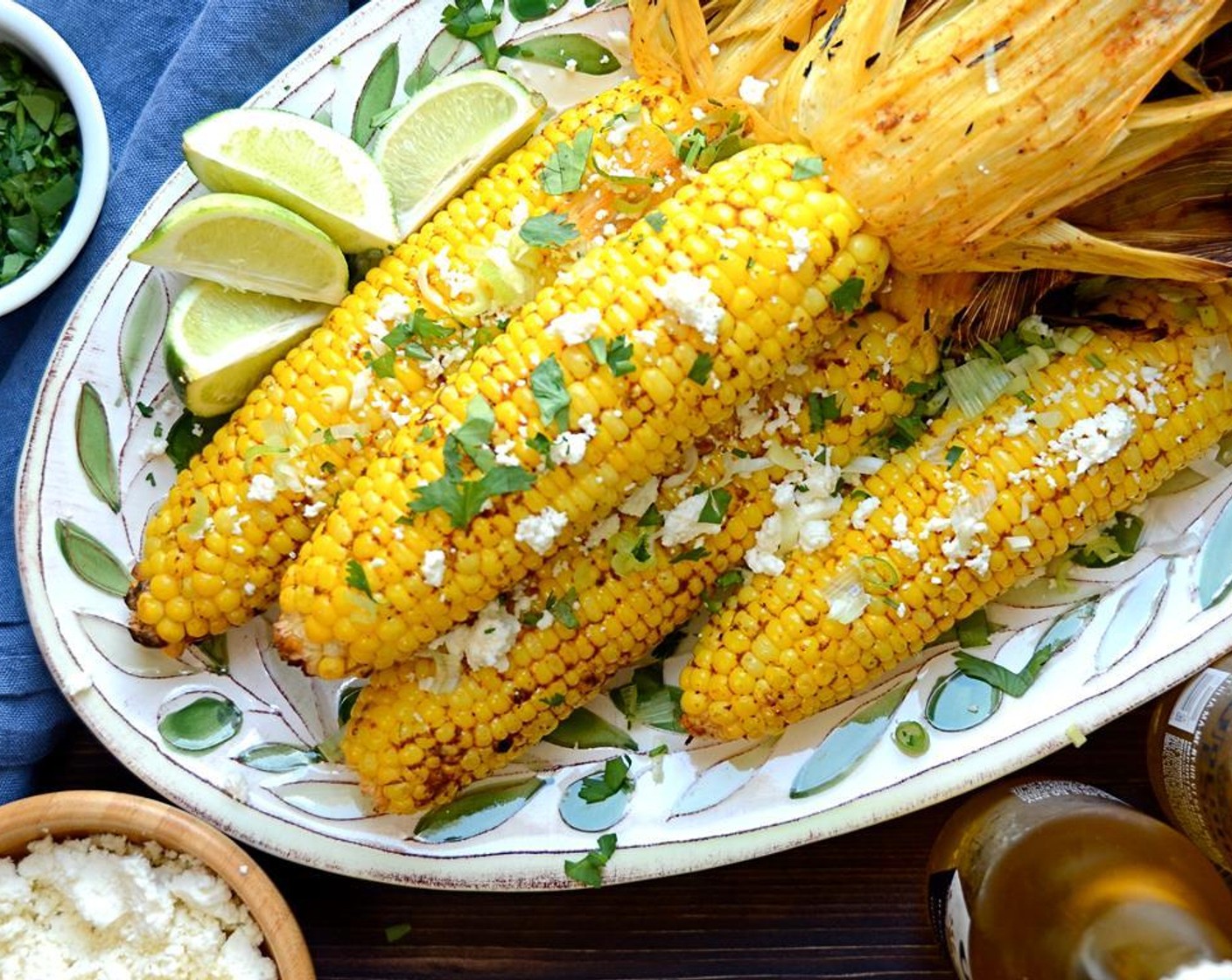 step 7 Sprinkle the corn with Fresh Cilantro (1/2 cup), Queso Fresco (1/2 cup), and Scallions (2). Serve the lime on the side for guests to squeeze onto the corn.