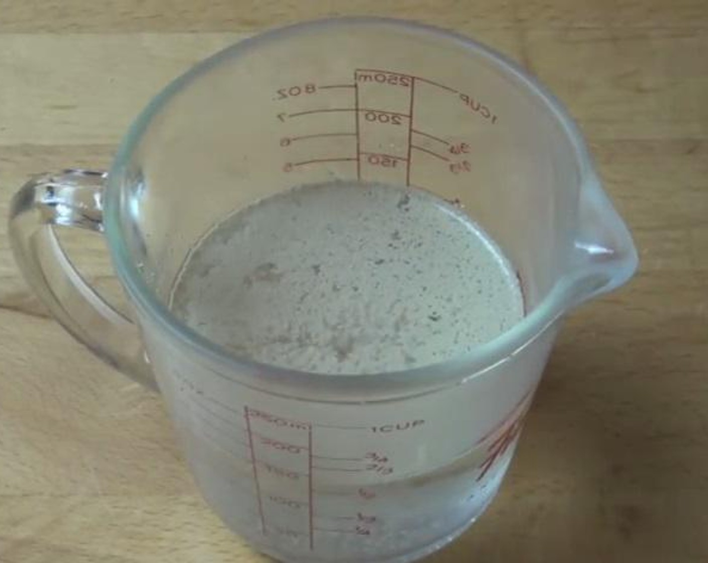 step 2 Into a small jug, add the Water (1/2 cup), Instant Dry Yeast (1/4 tsp), and Granulated Sugar (1 pinch). Stir through and set aside for about ten minutes until it is nice and firm.